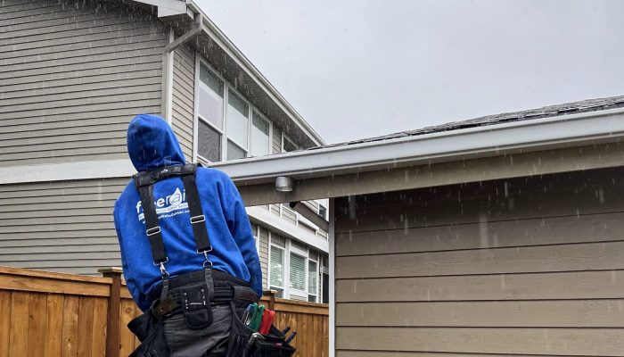 An image of a FreeRain employee installing new FreeRain gutters in the rain.